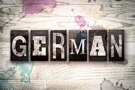 simsearch:400-08709089,k - The word "GERMAN" written in vintage, dirty metal letterpress type on a whitewashed wooden background with ink and paint stains. Foto de stock - Royalty-Free Super Valor e Assinatura, Número: 400-08709112