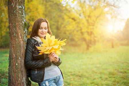 phantom1311 (artist) - Young woman with maple leaves in tree stands with shallow depth of field Stock Photo - Budget Royalty-Free & Subscription, Code: 400-08712402