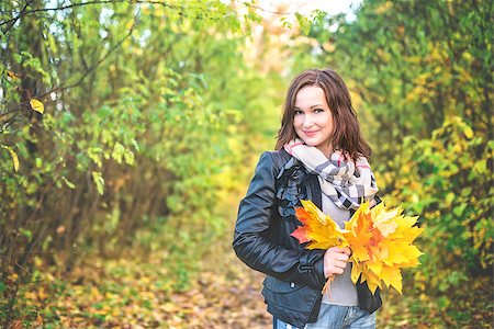 phantom1311 (artist) - Young woman holding tree leaves in the hands and smiling Stock Photo - Budget Royalty-Free & Subscription, Code: 400-08712413