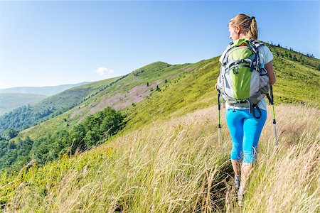 simsearch:400-08735364,k - Tourist with backpack standing on a rock Fotografie stock - Microstock e Abbonamento, Codice: 400-08729935