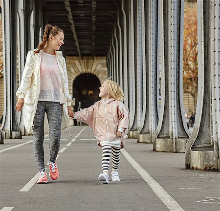 fitness female france outdoor - Year round fit & hip in Paris. Full length portrait of smiling healthy mother and child in sport style clothes on Pont de Bir-Hakeim bridge in Paris walking Stock Photo - Budget Royalty-Free & Subscription, Code: 400-08734394