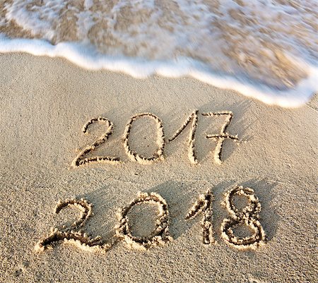 2017 2018 inscription written in the wet beach sand with sea water wave. Inscription 2017 and 2018 on a beach sand, the wave is almost covering the digits 2017. Stock Photo - Budget Royalty-Free & Subscription, Code: 400-08734489