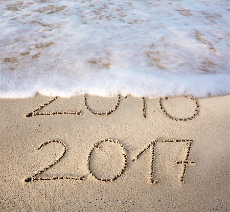 2016 2017 inscription written in the wet beach sand with sea water wave. Inscription 2016 and 2017 on a beach sand, the wave is almost covering the digits 2016. Stock Photo - Budget Royalty-Free & Subscription, Code: 400-08734491