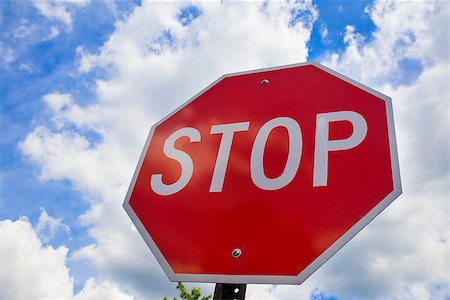 Red stop sign on the street, roadside traffic sign for stopping. Stock Photo - Budget Royalty-Free & Subscription, Code: 400-08734833