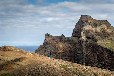 simsearch:400-08735364,k - Tourist is watching his gps map near the high cliff. Scenic hiking path to the eastern cape of Madeira island. Madeira, Portugal. Fotografie stock - Microstock e Abbonamento, Codice: 400-08735367