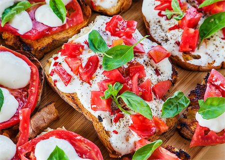 sandwich rustic table - Creamy cheese over crispy toasts topped with tomatoes and basil. Horizontal image. Stock Photo - Budget Royalty-Free & Subscription, Code: 400-08735547