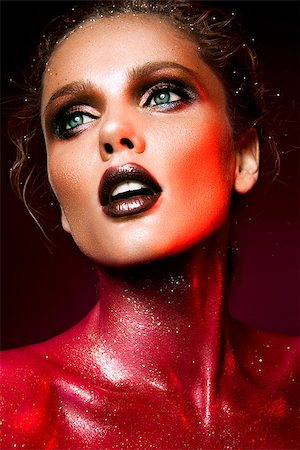 simsearch:400-04821060,k - Beautiful woman with red make up and glitter on the neck and hair Photographie de stock - Aubaine LD & Abonnement, Code: 400-08735893