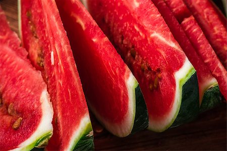 simsearch:400-05886533,k - Juicy watermelon slices lying on wooden surface. Close up view. Photographie de stock - Aubaine LD & Abonnement, Code: 400-08736043