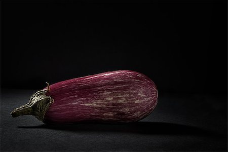 striped tomato - Fresh striped zebra eggplant on black background Stock Photo - Budget Royalty-Free & Subscription, Code: 400-08736204