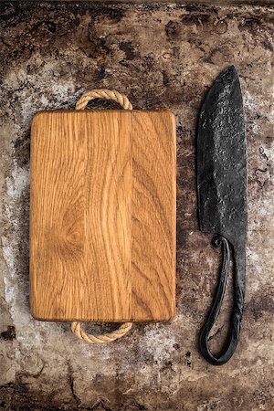 Wooden chopping board and old knife on rustic table Stock Photo - Budget Royalty-Free & Subscription, Code: 400-08736676