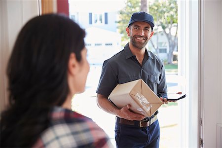 Woman Receiving Package From Courier At Home Stock Photo - Budget Royalty-Free & Subscription, Code: 400-08737189