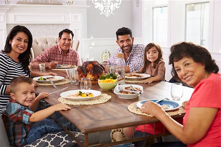 simsearch:400-08292251,k - Extended Hispanic Family Enjoying Meal At Table Stock Photo - Budget Royalty-Free & Subscription, Code: 400-08737194