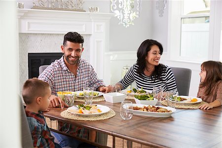 simsearch:400-08292251,k - Hispanic Family Enjoying Meal At Table Stock Photo - Budget Royalty-Free & Subscription, Code: 400-08737196
