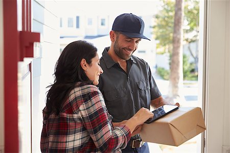 Woman Signing For Package From Courier At Home Stock Photo - Budget Royalty-Free & Subscription, Code: 400-08737191