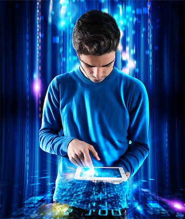 Teen boy touching the screen of a tablet with background blue lights Photographie de stock - Aubaine LD & Abonnement, Code: 400-08730233