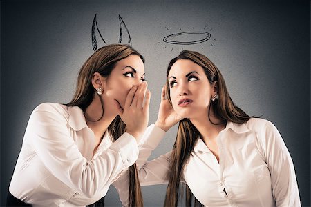 Girl with devil horns speaks to a girl as an angel with a halo Stock Photo - Budget Royalty-Free & Subscription, Code: 400-08730572