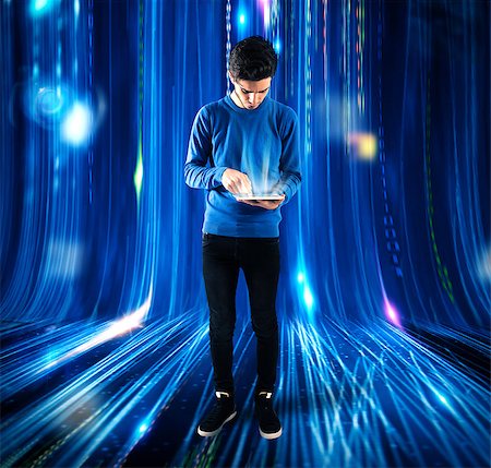 Boy touches the screen of a tablet with background lights Stock Photo - Budget Royalty-Free & Subscription, Code: 400-08730834