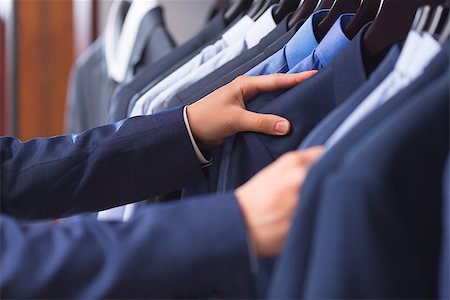 fashion store manager - Male hand choosing a shirt Stock Photo - Budget Royalty-Free & Subscription, Code: 400-08731191