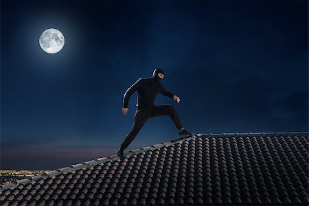 simsearch:400-05729571,k - Thief dressed in black walking on the roof of a house Stock Photo - Budget Royalty-Free & Subscription, Code: 400-08731223