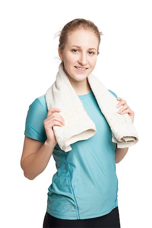 Smiling happy female fitness model with a towel looking at camera isolated on white background Stock Photo - Budget Royalty-Free & Subscription, Code: 400-08731317