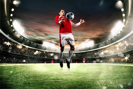 Football player parry the ball in the field of a stadium Stock Photo - Budget Royalty-Free & Subscription, Code: 400-08731324