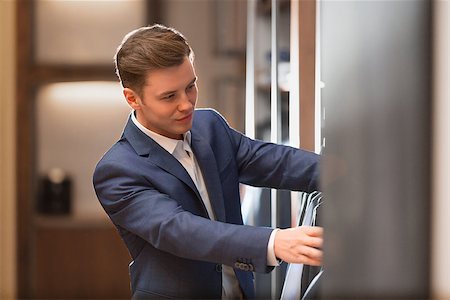 fashion store manager - Young man in suit in store Stock Photo - Budget Royalty-Free & Subscription, Code: 400-08731709