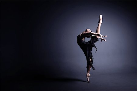 simsearch:400-04283453,k - Young ballerina in a black suit is dancing in a dark studio Stockbilder - Microstock & Abonnement, Bildnummer: 400-08731777