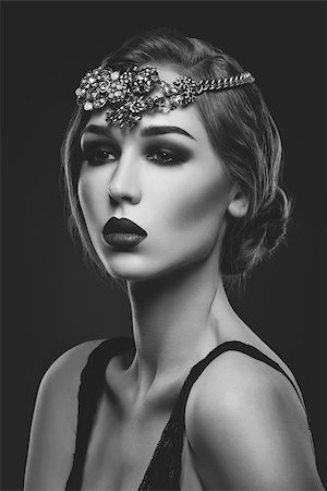 simsearch:400-04974367,k - Beautiful young woman with smoky eyes and full red lips. Massive crystal hair accessory on head. Retro styling. Studio beauty shot. Copy space. Monochrome. Photographie de stock - Aubaine LD & Abonnement, Code: 400-08732548