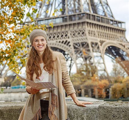 simsearch:400-09031587,k - Autumn getaways in Paris. smiling young tourist woman on embankment in Paris, France  holding map and looking into the distance Stock Photo - Budget Royalty-Free & Subscription, Code: 400-08733689