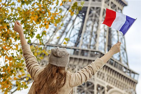 simsearch:400-09031587,k - Autumn getaways in Paris. Seen from behind young elegant woman on embankment in Paris, France rising flag Stock Photo - Budget Royalty-Free & Subscription, Code: 400-08733683