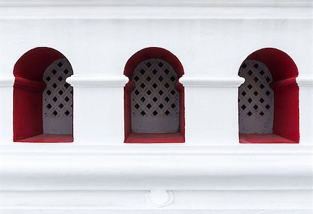 Small red window for ventilation on the white wall of the Thai temple.(Public area not required Property Release) Foto de stock - Royalty-Free Super Valor e Assinatura, Número: 400-08733848