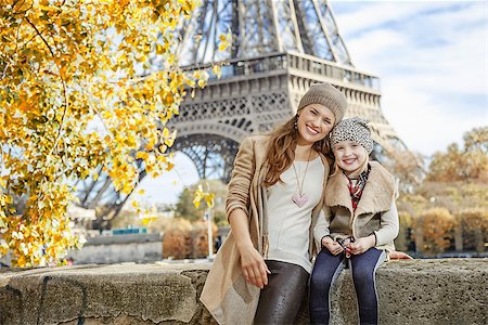 simsearch:400-09031587,k - Autumn getaways in Paris with family. Portrait of happy mother and child tourists on embankment in Paris, France sitting on the parapet Stock Photo - Budget Royalty-Free & Subscription, Code: 400-08733953