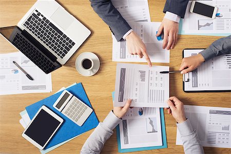 financial meeting tablet - Business people brainstorming at office desk, they are analyzing financial reports and pointing out financial data on a sheet, top view Stock Photo - Budget Royalty-Free & Subscription, Code: 400-08749567