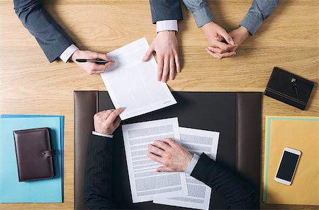 Business man and woman sitting at the lawyers's desk and signing important documents, hands top view, unrecognizable people Photographie de stock - Aubaine LD & Abonnement, Code: 400-08749585