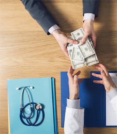 doctors office insurance patient - Male patient having a medical visit and bribing a greedy doctor with a lot of money, top view unrecognizable people Stock Photo - Budget Royalty-Free & Subscription, Code: 400-08749581