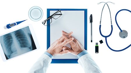 simsearch:400-08751444,k - Doctor with hands clasped waiting at desk on white background, top view, healthcare and prevention concept Photographie de stock - Aubaine LD & Abonnement, Code: 400-08749666