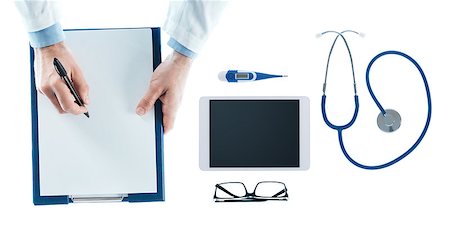 simsearch:400-08751444,k - Doctor at desk writing a prescription on a clipboard on white background, top view Photographie de stock - Aubaine LD & Abonnement, Code: 400-08749660