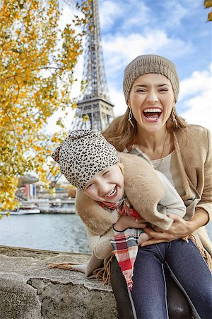 simsearch:400-09031587,k - Autumn getaways in Paris with family. happy mother and child tourists on embankment in Paris, France having fun time Stock Photo - Budget Royalty-Free & Subscription, Code: 400-08749877