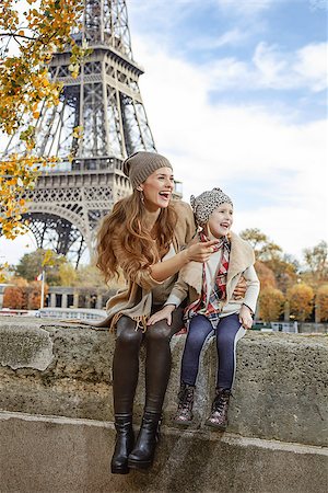 simsearch:400-09031587,k - Autumn getaways in Paris with family. happy mother and daughter tourists on embankment in Paris, France pointing on something while sitting on the parapet Stock Photo - Budget Royalty-Free & Subscription, Code: 400-08749879