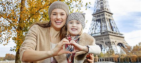 fall pictures of paris - Autumn getaways in Paris with family. Portrait of happy mother and daughter tourists on embankment near Eiffel tower in Paris, France showing heart shaped hands Stock Photo - Budget Royalty-Free & Subscription, Code: 400-08749873