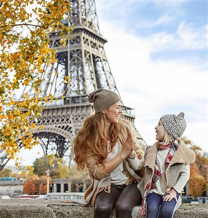 simsearch:400-09031587,k - Autumn getaways in Paris with family. smiling mother and child travellers playing on embankment near Eiffel tower in Paris, France Stock Photo - Budget Royalty-Free & Subscription, Code: 400-08749880