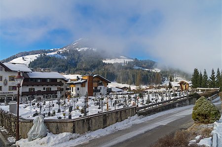 Cemetery in Kirchberg in Tyrol, Austria. Sunny winter morning, low clouds. Stock Photo - Budget Royalty-Free & Subscription, Code: 400-08755288
