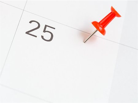 Red pin pinned on the 25th date of the month on calendar paper Stock Photo - Budget Royalty-Free & Subscription, Code: 400-08755812