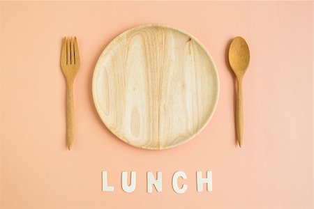 Top view of wooden dish fork spoon with lunch wording on light orange background Stock Photo - Budget Royalty-Free & Subscription, Code: 400-08759093