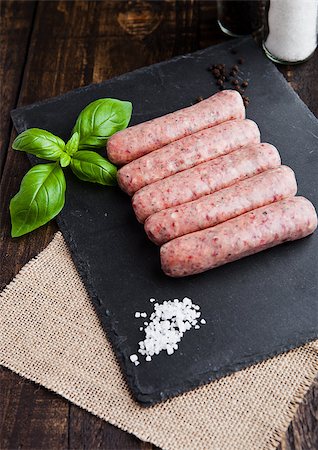 simsearch:400-07713408,k - Raw beef sausages with salt and basil on stone board.Dark brown board. Salt and pepper on background Stock Photo - Budget Royalty-Free & Subscription, Code: 400-08759234