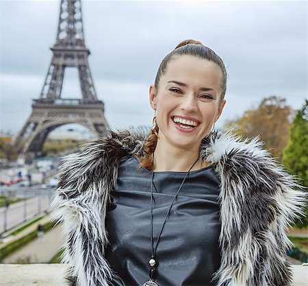 fall pictures of paris - The Party Season in Paris. Portrait of happy modern fashion-monger in fur coat standing against Eiffel tower in Paris, France Stock Photo - Budget Royalty-Free & Subscription, Code: 400-08750104