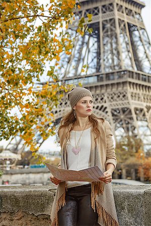simsearch:400-09031587,k - Autumn getaways in Paris. young elegant woman on embankment near Eiffel tower in Paris, France holding map and looking into the distance Stock Photo - Budget Royalty-Free & Subscription, Code: 400-08750535