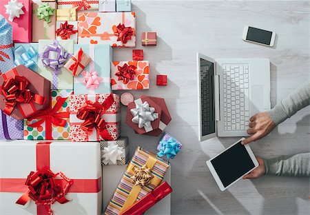 simsearch:400-08749588,k - Man sitting at desk using a tablet and plenty of colorful gifts, celebrations and Christmas concept Stock Photo - Budget Royalty-Free & Subscription, Code: 400-08751393