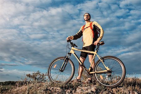 Mountain Bike cyclist riding single track above sunset valley against blue sky Stock Photo - Budget Royalty-Free & Subscription, Code: 400-08751689