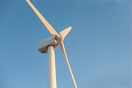 Electric wind turbines farm over blue sky with wake plane, Spain Stockbilder - Microstock & Abonnement, Bildnummer: 400-08751748